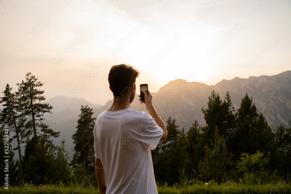 Man taking photo with phone in nature Man taking photo with phone in nature