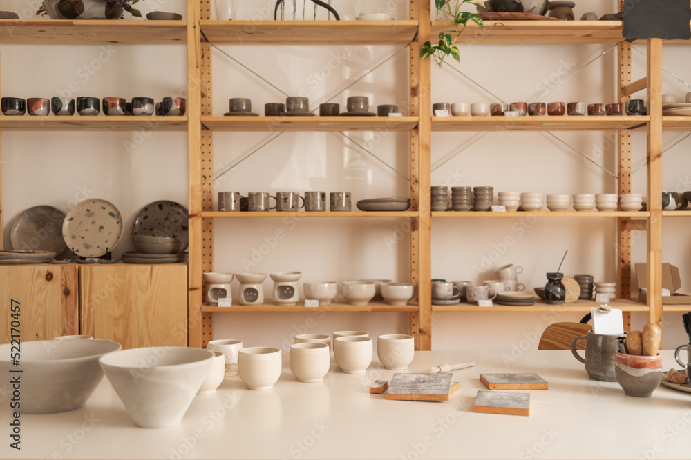 A Shelf Showcasing Handcrafted Objects In The Ceramics Shop A Shelf Showcasing Handcrafted Objects In The Ceramics Shop