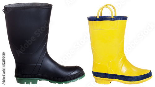Foto Black wellington boot with thick green sole and child's yellow boot with handles
