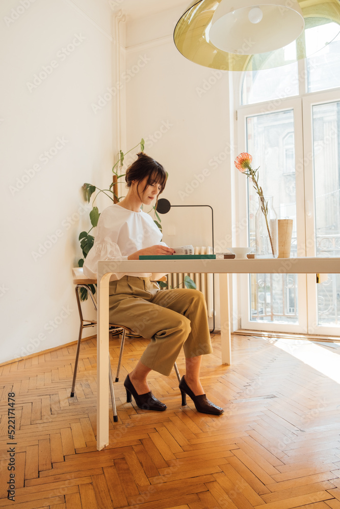 Beautiful Woman Sitting at Desk in Studio Beautiful Woman Sitting at Desk in Studio