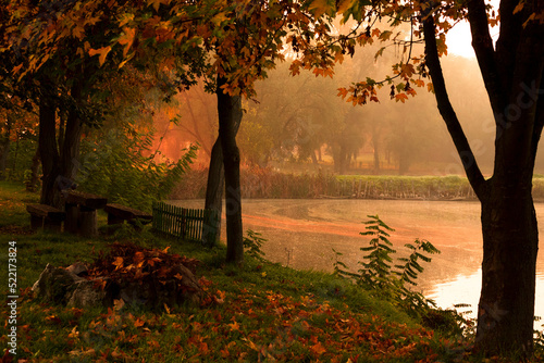 autumn forest at sunrise and a lake