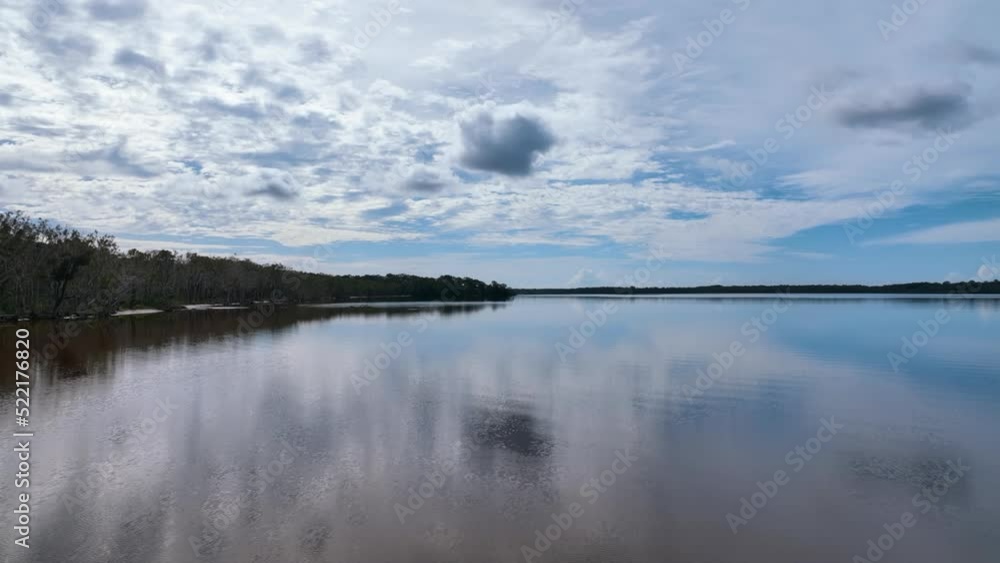 Low aerial over the mirrored surface of Lake Cootharaba in Autumn Australia Low aerial over the mirrored surface of Lake Cootharaba in Autumn Australia
