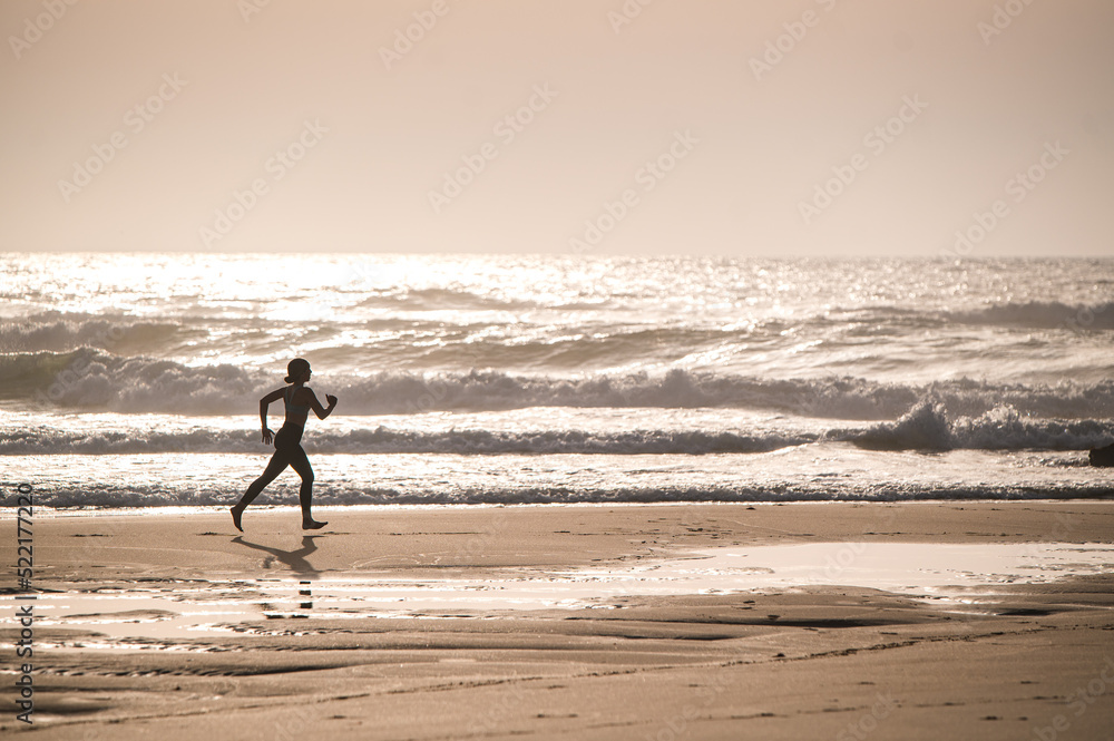 Active woman running along waving sea Active woman running along waving sea