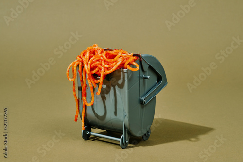 cooked spaghetti in a waste container photo