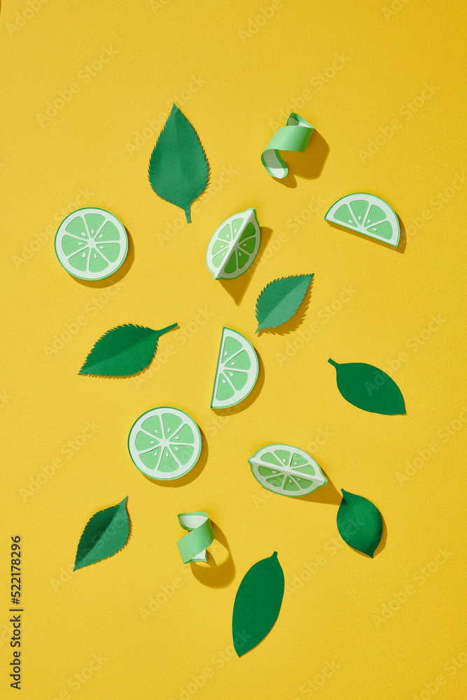 Citrus fruits lime with paper carved leaves. Paper cut concept Citrus fruits lime with paper carved leaves. Paper cut concept