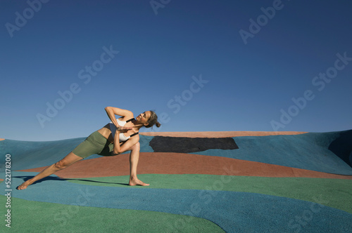 Female doing  yoga asana outdoor  photo