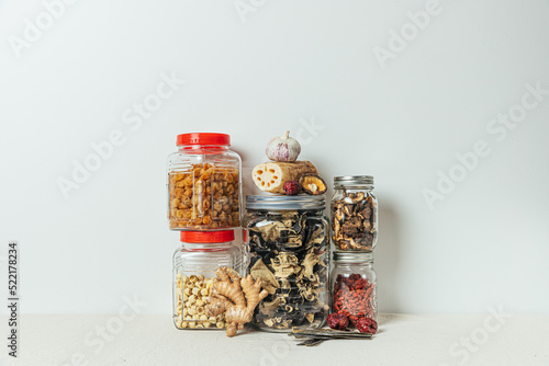 Dried pantry ingredients and fresh produce in jars photo