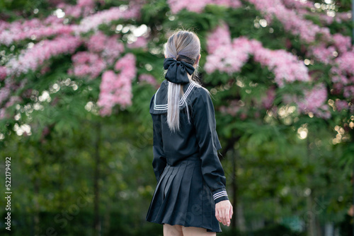 Konstfotografi Woman wearing cosplay Japanese school uniform at park outdoor.