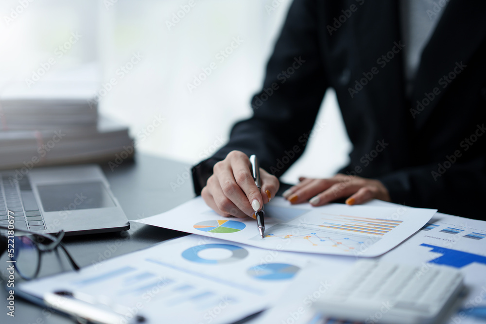 Close-up of business woman hands to check company finances and earnings and budget. Business people calculating monthly expenses, managing budget, papers, loan documents, invoices. Close-up of business woman hands to check company finances and earnings and budget. Business people calculating monthly expenses, managing budget, papers, loan documents, invoices.