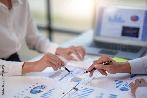 Business people analyzes  graphs and charts to examine and analyze company finances  revenues and budgets for new business operations in the next project.