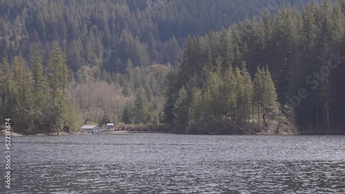 View of Canadian Nature Landscape. Green Trees, Mountains, and Water. Sunny Spring Season. Buntzen Lake, Anmore, Vancouver, BC, Canada. Background. Slow Motion photo