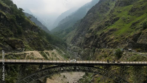 Aerial shot of a dangerous bridge in Himachal Pradesh. Car crossing the bridge.