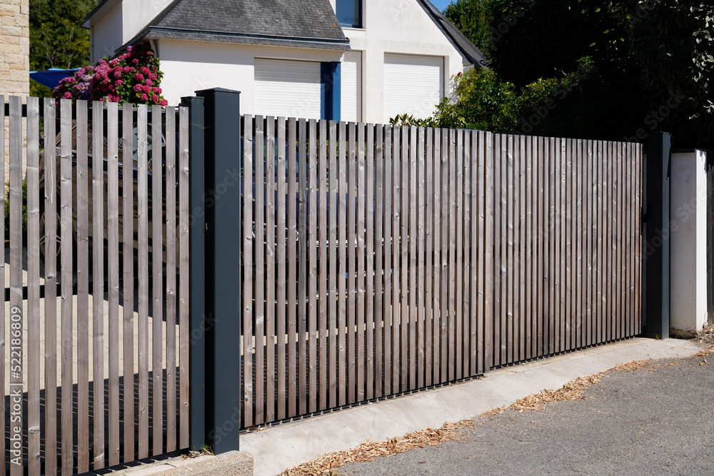 Brown entry wooden gate closed of modern house suburb wood portal access home door Brown entry wooden gate closed of modern house suburb wood portal access home door