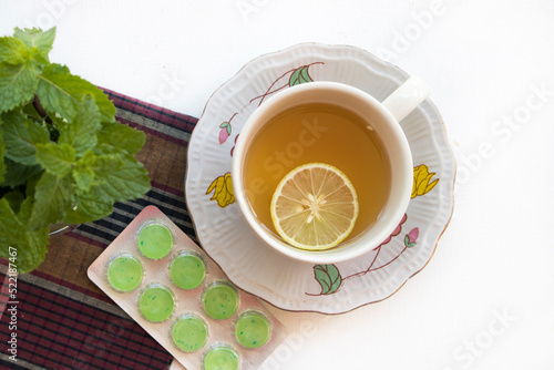 Fotografie herbal drinks lemon with lozenge for health care arrangement flat lay style on b