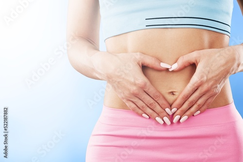 Wallpaper Mural Young healthy woman hand made heart shape on her stomach. Concept of good digestive, healthy gut, probiotics, slim fit, gynecology and woman health care. Torontodigital.ca