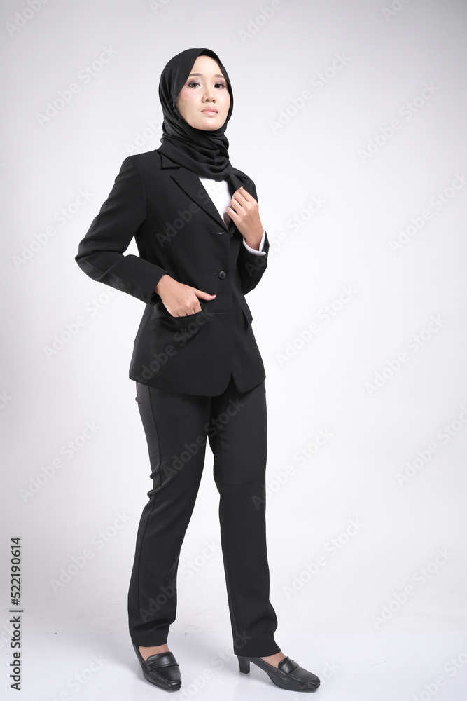 Portrait of a female wearing a hijab, a form of lifestyle garments for Muslim women, isolated on a dark background. Eid festive and hijab fashion concept Portrait of a female wearing a hijab, a form of lifestyle garments for Muslim women, isolated on a dark background. Eid festive and hijab fashion concept