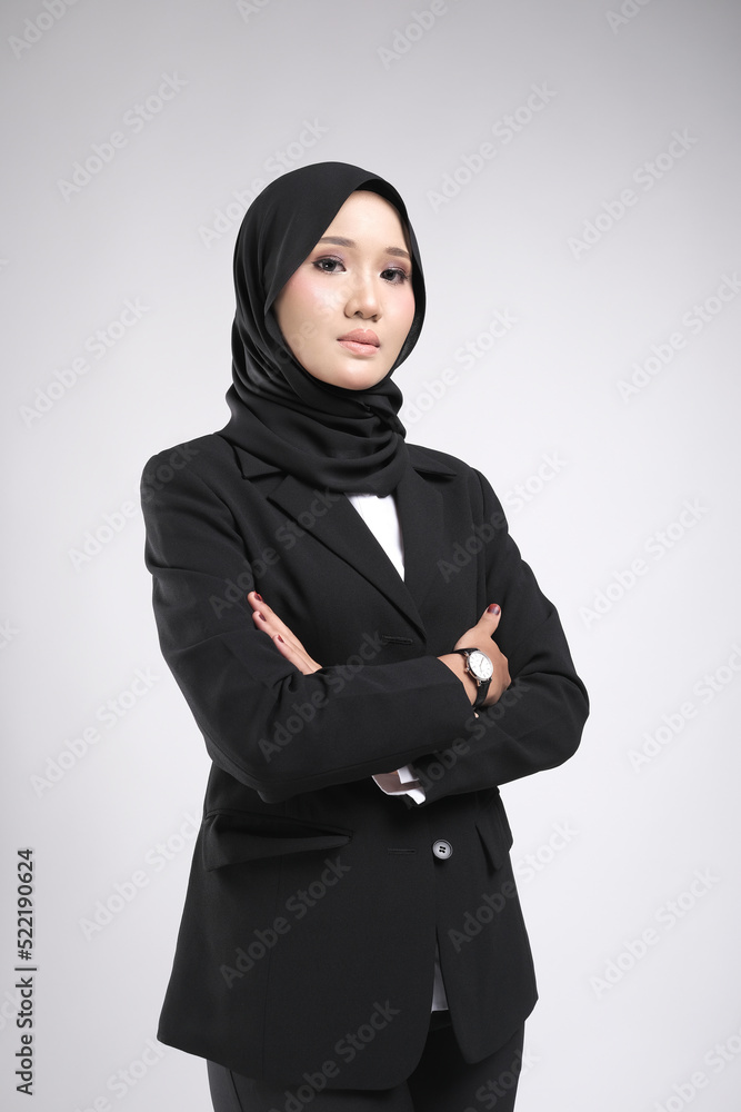 Portrait of a female wearing a hijab, a form of lifestyle garments for Muslim women, isolated on a dark background. Eid festive and hijab fashion concept Portrait of a female wearing a hijab, a form of lifestyle garments for Muslim women, isolated on a dark background. Eid festive and hijab fashion concept