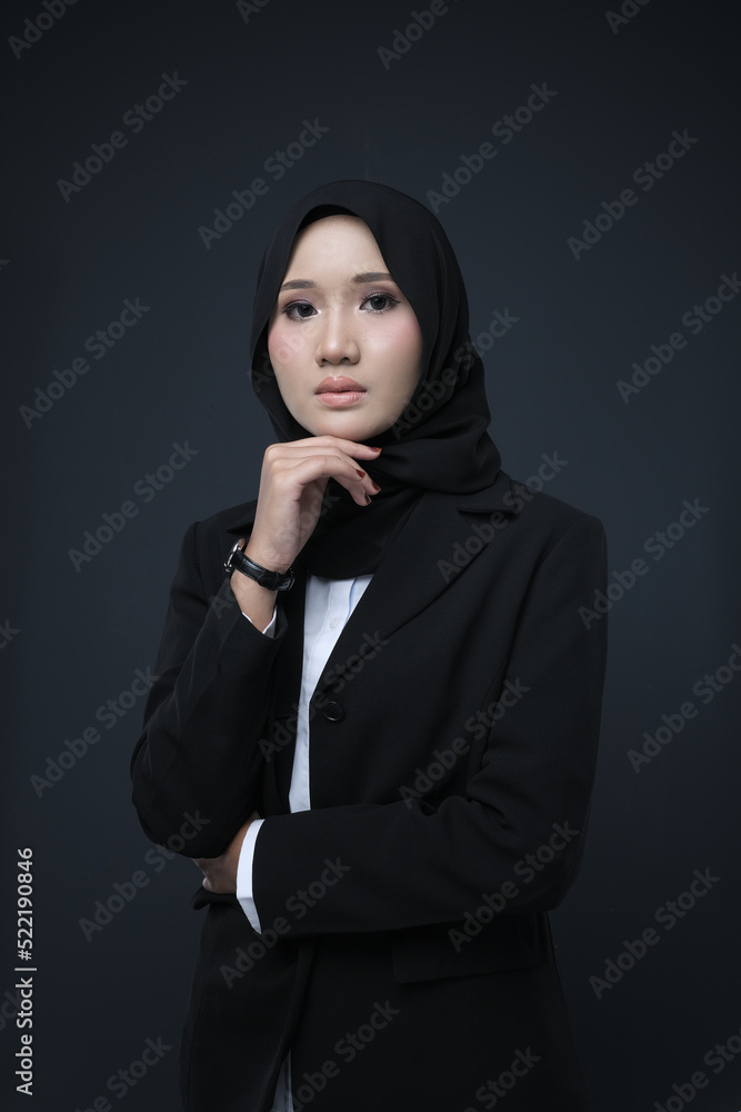 Portrait of a female wearing a hijab, a form of lifestyle garments for Muslim women, isolated on a background. Eid festive and hijab fashion concept Portrait of a female wearing a hijab, a form of lifestyle garments for Muslim women, isolated on a background. Eid festive and hijab fashion concept