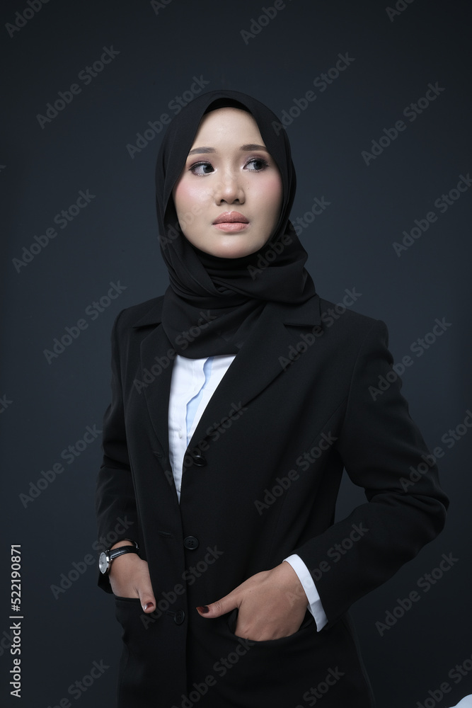 Portrait of a female wearing a hijab, a form of lifestyle garments for Muslim women, isolated on a background. Eid festive and hijab fashion concept Portrait of a female wearing a hijab, a form of lifestyle garments for Muslim women, isolated on a background. Eid festive and hijab fashion concept