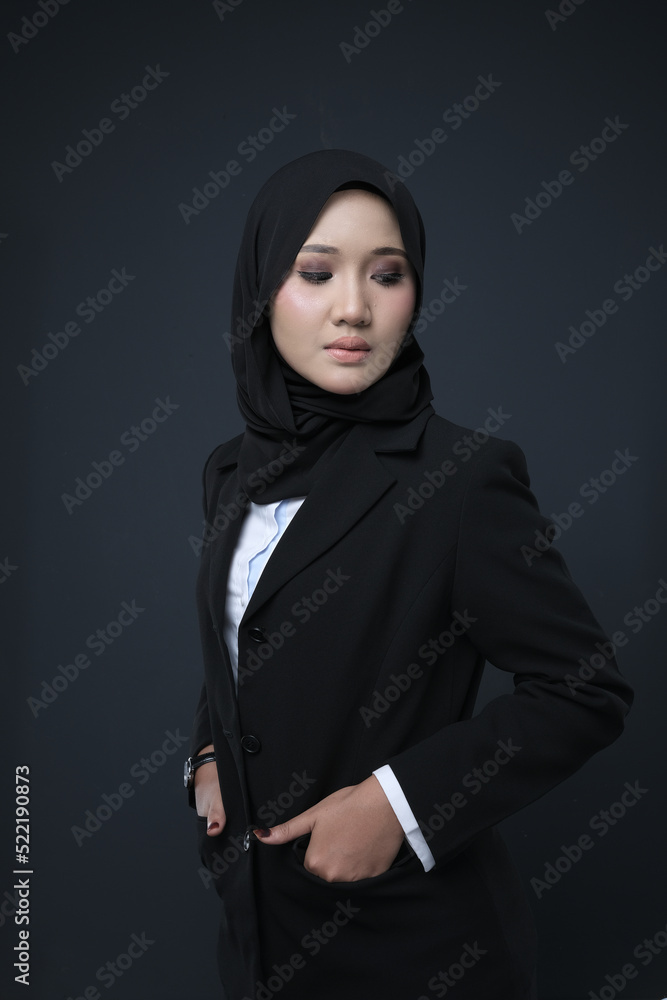 Portrait of a female wearing a hijab, a form of lifestyle garments for Muslim women, isolated on a background. Eid festive and hijab fashion concept Portrait of a female wearing a hijab, a form of lifestyle garments for Muslim women, isolated on a background. Eid festive and hijab fashion concept