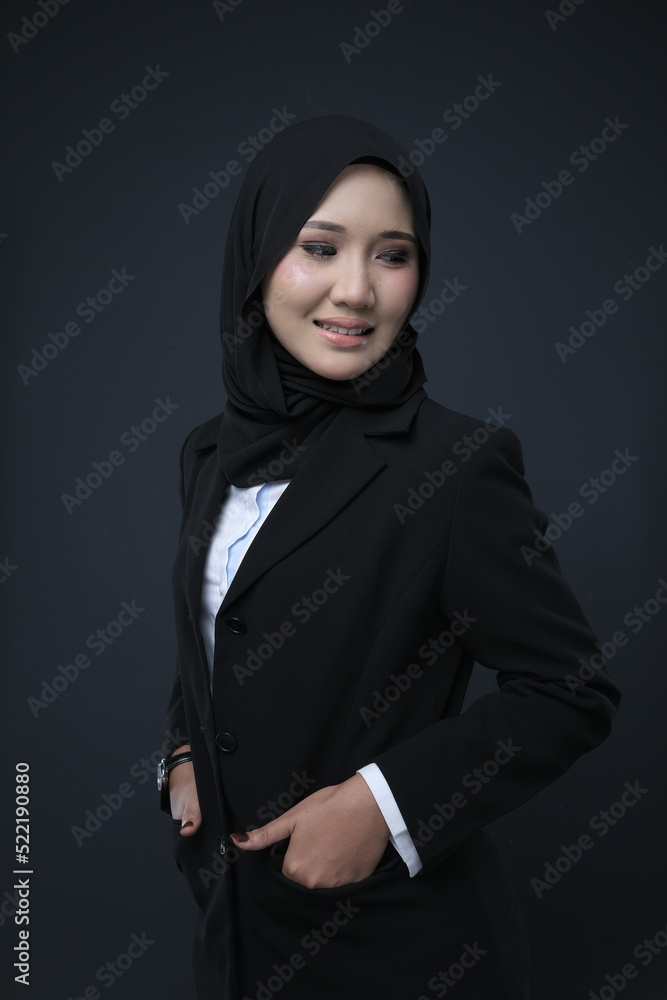 Portrait of a female wearing a hijab, a form of lifestyle garments for Muslim women, isolated on a background. Eid festive and hijab fashion concept Portrait of a female wearing a hijab, a form of lifestyle garments for Muslim women, isolated on a background. Eid festive and hijab fashion concept
