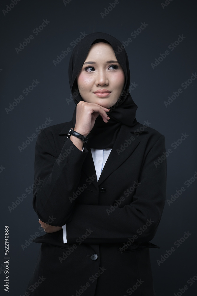 Portrait of a female wearing a hijab, a form of lifestyle garments for Muslim women, isolated on a background. Eid festive and hijab fashion concept Portrait of a female wearing a hijab, a form of lifestyle garments for Muslim women, isolated on a background. Eid festive and hijab fashion concept