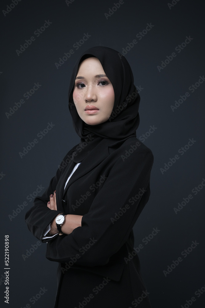Portrait of a female wearing a hijab, a form of lifestyle garments for Muslim women, isolated on a background. Eid festive and hijab fashion concept Portrait of a female wearing a hijab, a form of lifestyle garments for Muslim women, isolated on a background. Eid festive and hijab fashion concept