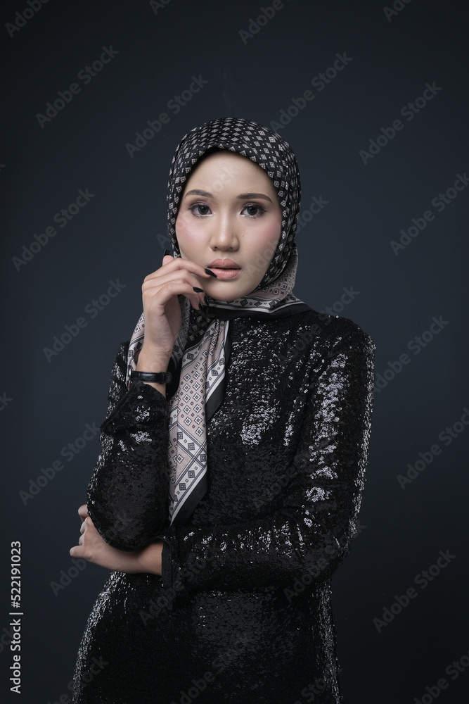 Portrait of a female wearing a hijab, a form of lifestyle garments for Muslim women, isolated on a background. Eid festive and hijab fashion concept Portrait of a female wearing a hijab, a form of lifestyle garments for Muslim women, isolated on a background. Eid festive and hijab fashion concept