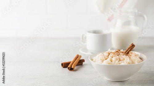  Scandinavian rice porridge in a bowl with cinnamon. Healthy breakfast. Copy space