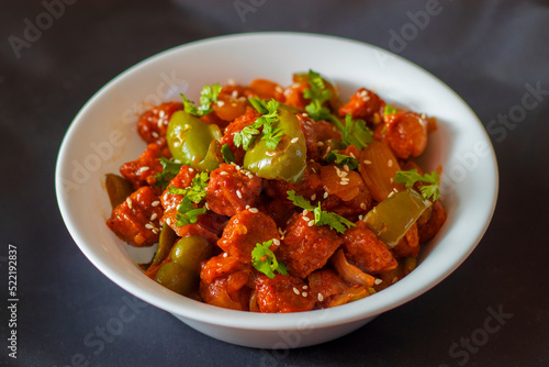 selective focus of Soya Manchurian/Chili Soya bean chunks recipe. with a decorative background.