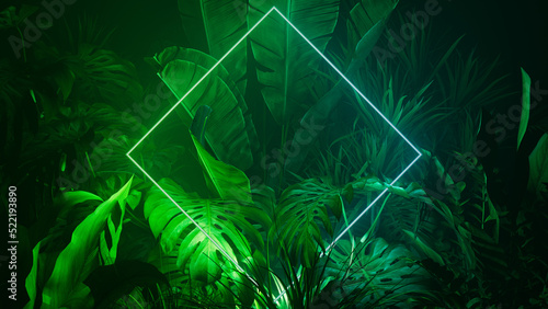 Tropical Leaves Illuminated with Blue and Green Fluorescent Light. Jungle Environment with Diamond shaped Neon Frame.