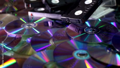 close-up a many compact discs and some hi-8 video casettes with moving lights