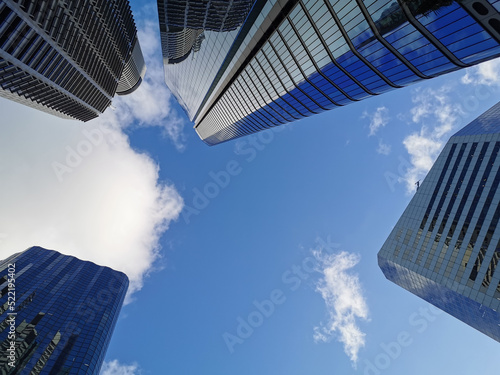 Lookup view of variety of coporate business high-rise skyscrapers buildings with blue bright sky in central business distric downtown