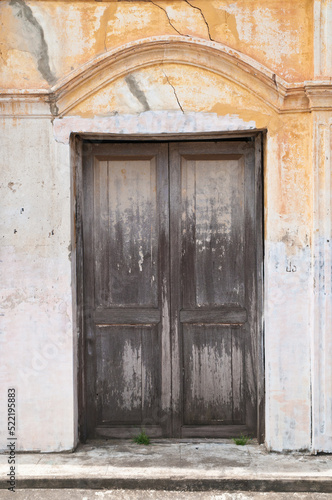 Old dark brown wooden closed door of a traditional house in Asia © eyeofpaul