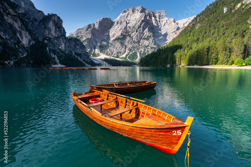 Amazing Sunrise view of Lago di Braies (Pragser Wildsee) with Wooden boats, one of the most beautiful lake in South Tirol, Dolomites mountains, Italy. Popular tourist attraction. © Songkhla Studio