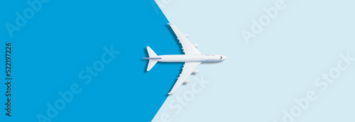 Flat lay design of travel concept with plane on blue background with copy space photo