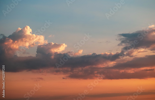 Orange and blue sunset sky. Beautiful clouds landscape in sunset light. Nature photography.
