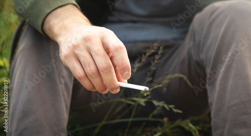 Man smoking cigarette in outdoor. Concept of smoking