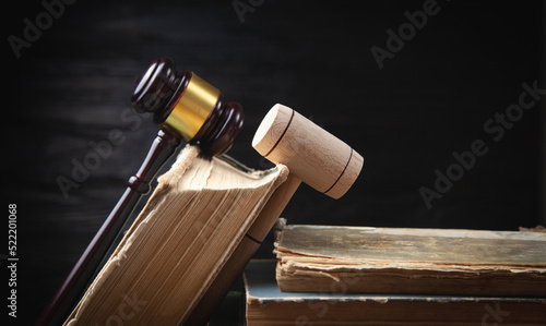 Judge gavel and book on the black background.