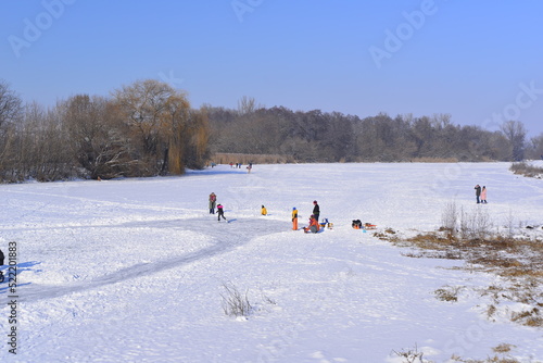 Family playing on frozen Mures river on Christmas day