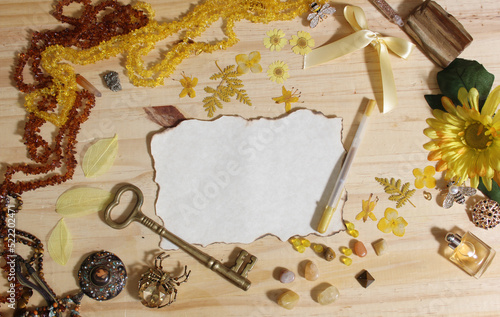 Yellow and Brown Jewelry and Decorations with Vintage Key and Blank Paper With Burned Edges