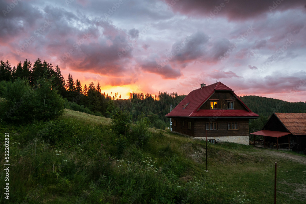 View of cabin in the woods at sunset in Valasska Bystrice, Czechia