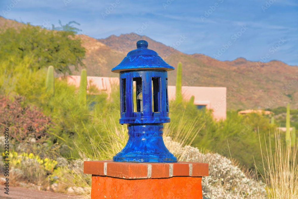 Blue column head lamp against the desert plants and mountain in Tucson, Arizona Blue column head lamp against the desert plants and mountain in Tucson, Arizona