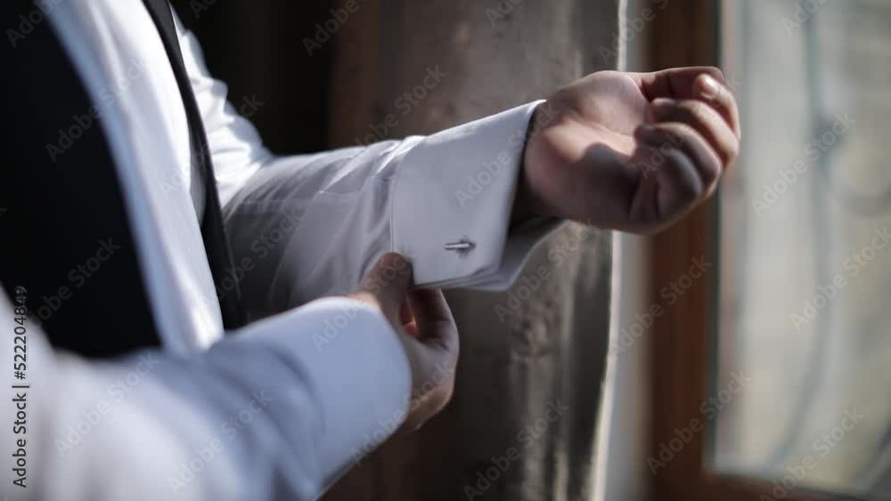 Love story, Groom adjusts the sleeve of his shirt Love story, Groom adjusts the sleeve of his shirt