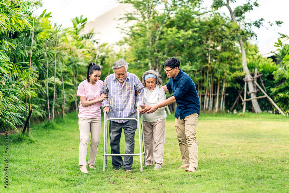 Portrait enjoy happy smiling love multi-generation asian big hug family.Senior mature father and elderly mother with young adult woman and son outdoor in park at home.insurance concept Portrait enjoy happy smiling love multi-generation asian big hug family.Senior mature father and elderly mother with young adult woman and son outdoor in park at home.insurance concept