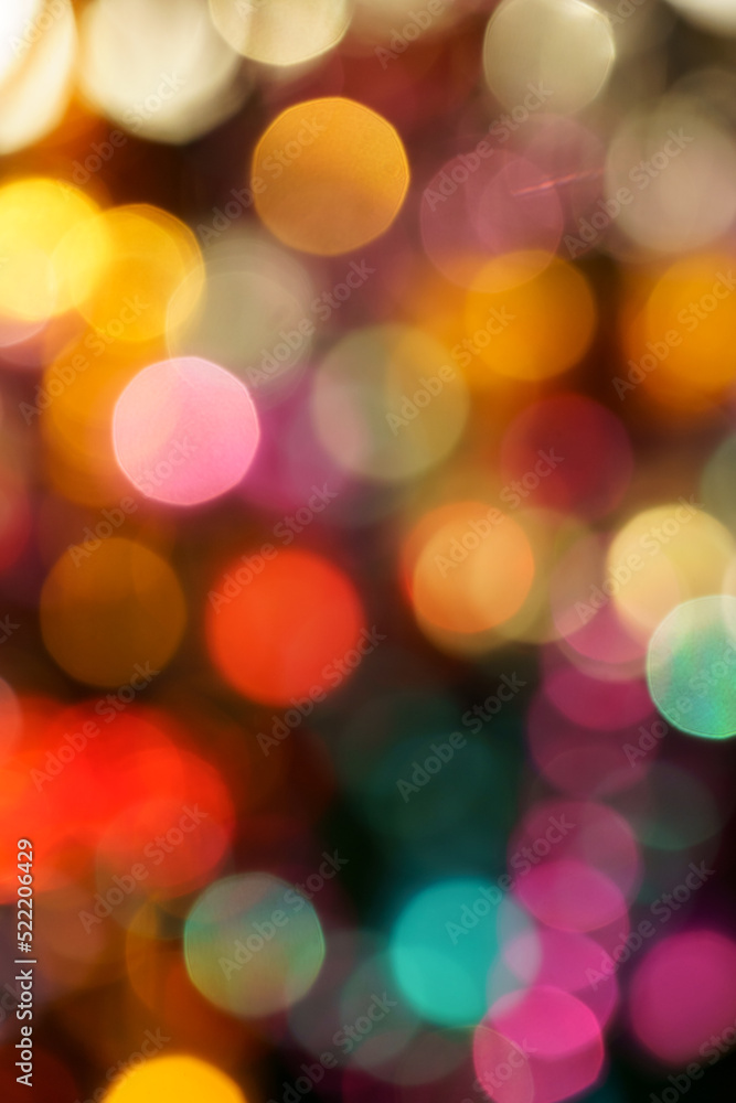 City lights at night in background with colorful lights, blurred focus. Festive abstract defocused colored neon light background with circular bokeh, closeup. City lights at night in background with colorful lights, blurred focus. Festive abstract defocused colored neon light background with circular bokeh, closeup.
