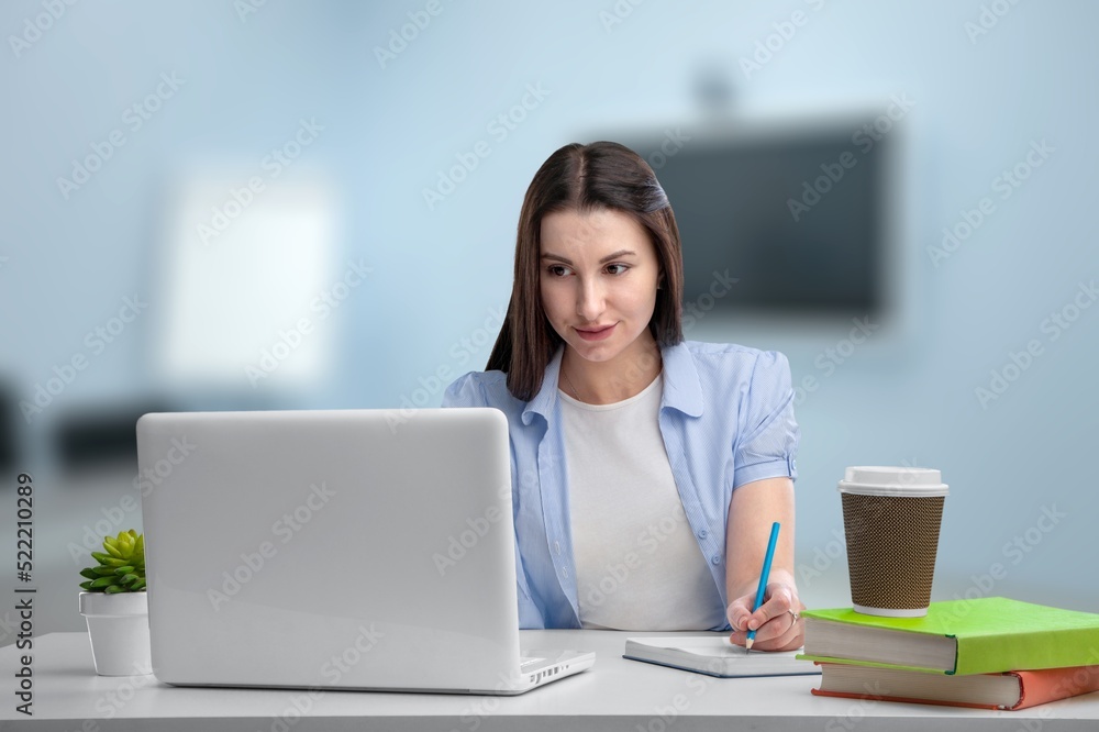 Marketing agency office person having management documentation while sitting at desk. Young confident business person