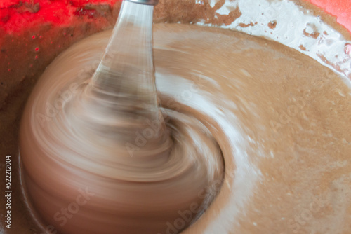 beat with a mixer with brown cake cream. pastry liquid smeared on kitchen utensils. there are air bubbles on the surface of the cream.