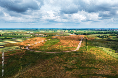 Aerial shot of old abandoned horse race track in plain landscape, drone pov photo