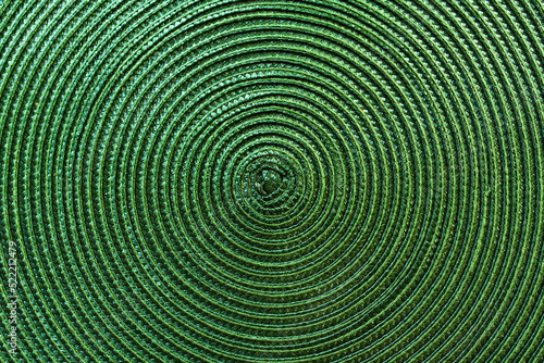 Texture of green plastic woven placemat on dining table